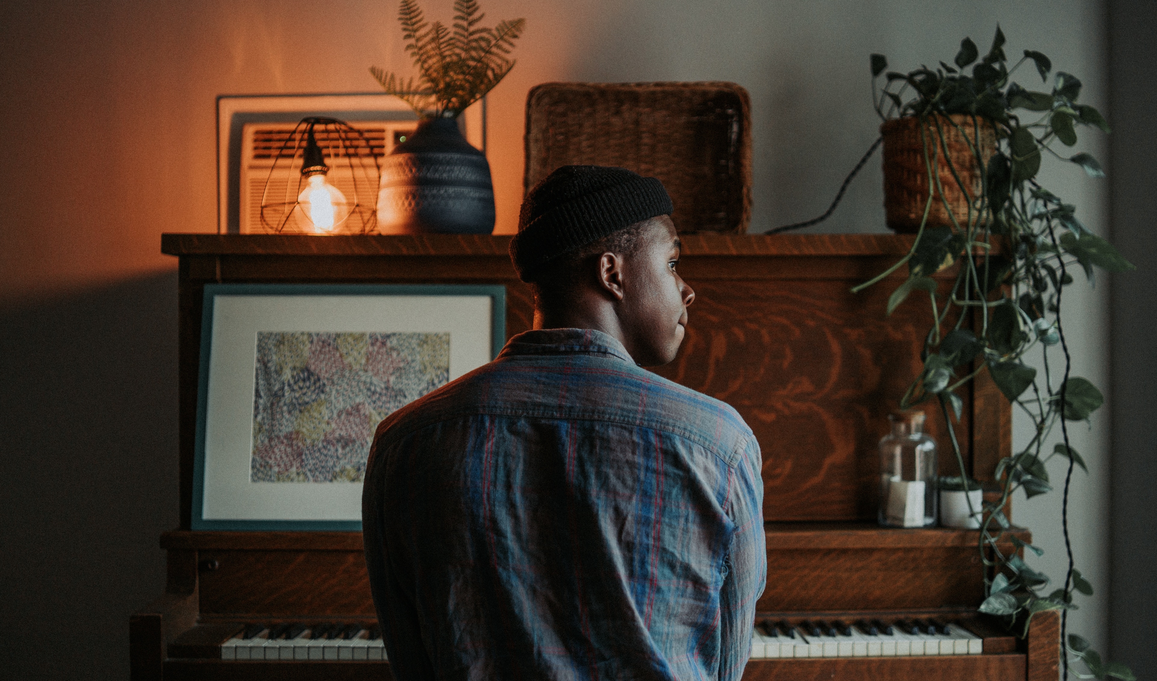 Man sitting at the piano Photo by George Coletrain on Unsplash