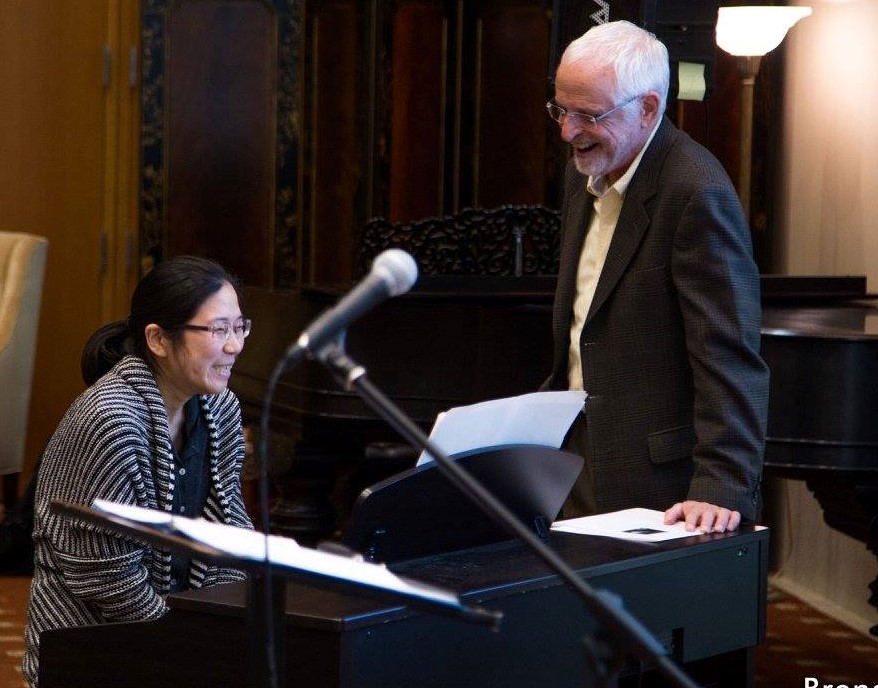 William Westney and woman laughing at piano