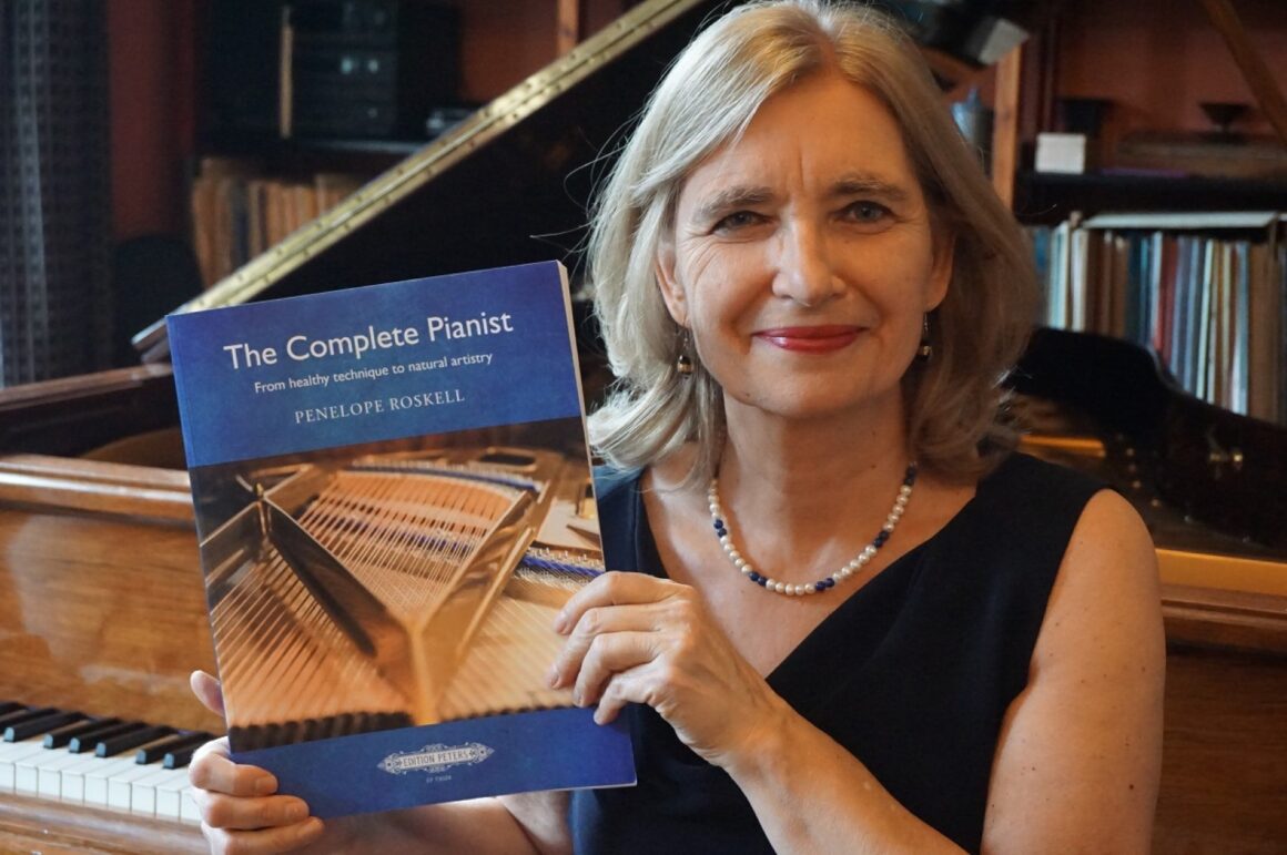 Penelope Roskell holding her book The Complete Pianist