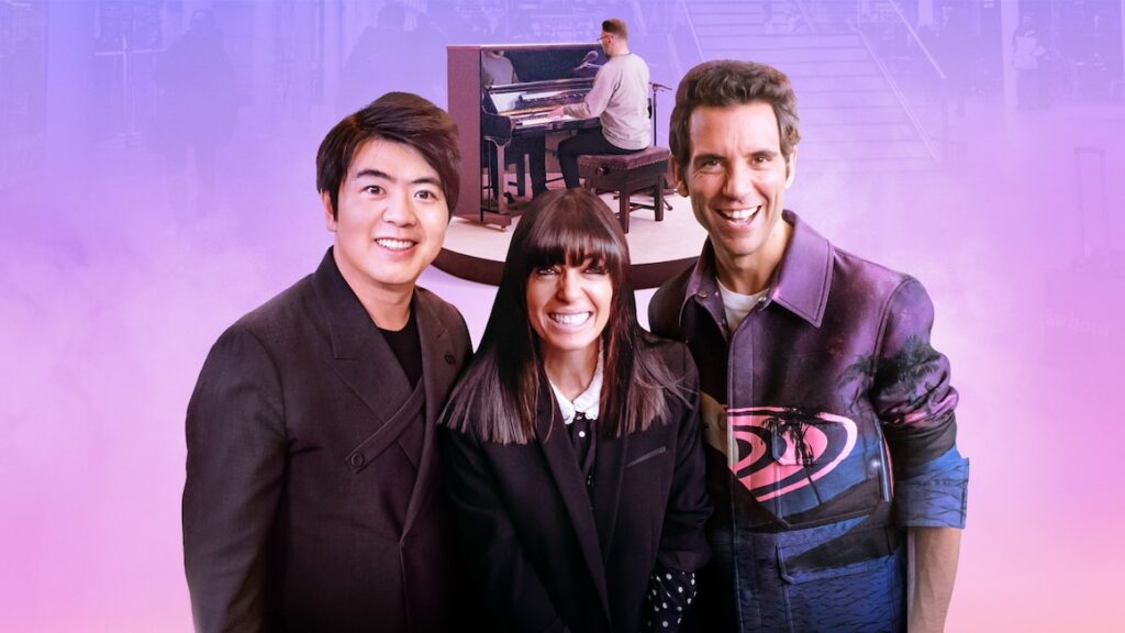 Lanng Lang, Claudia Winkelman & Mike smiling in the foreground, with pianist playing an acoustic upright in the background.
