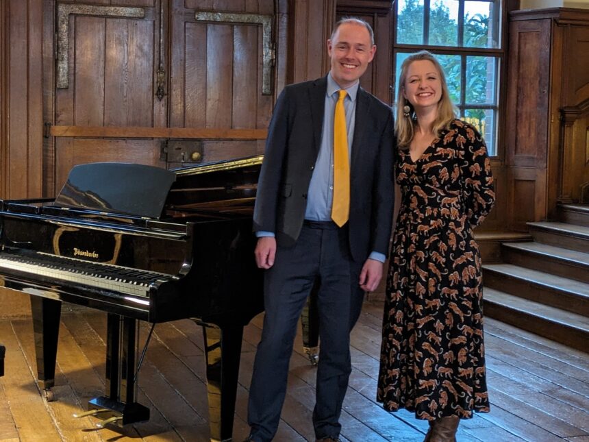 David Hall and Jennifer Maslin stand in Finchcocks main hall front right of the Bosendorfer smiling